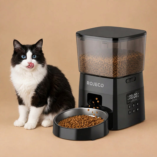 Cat sitting next to a ROJECO pet feeder on a wooden floor.