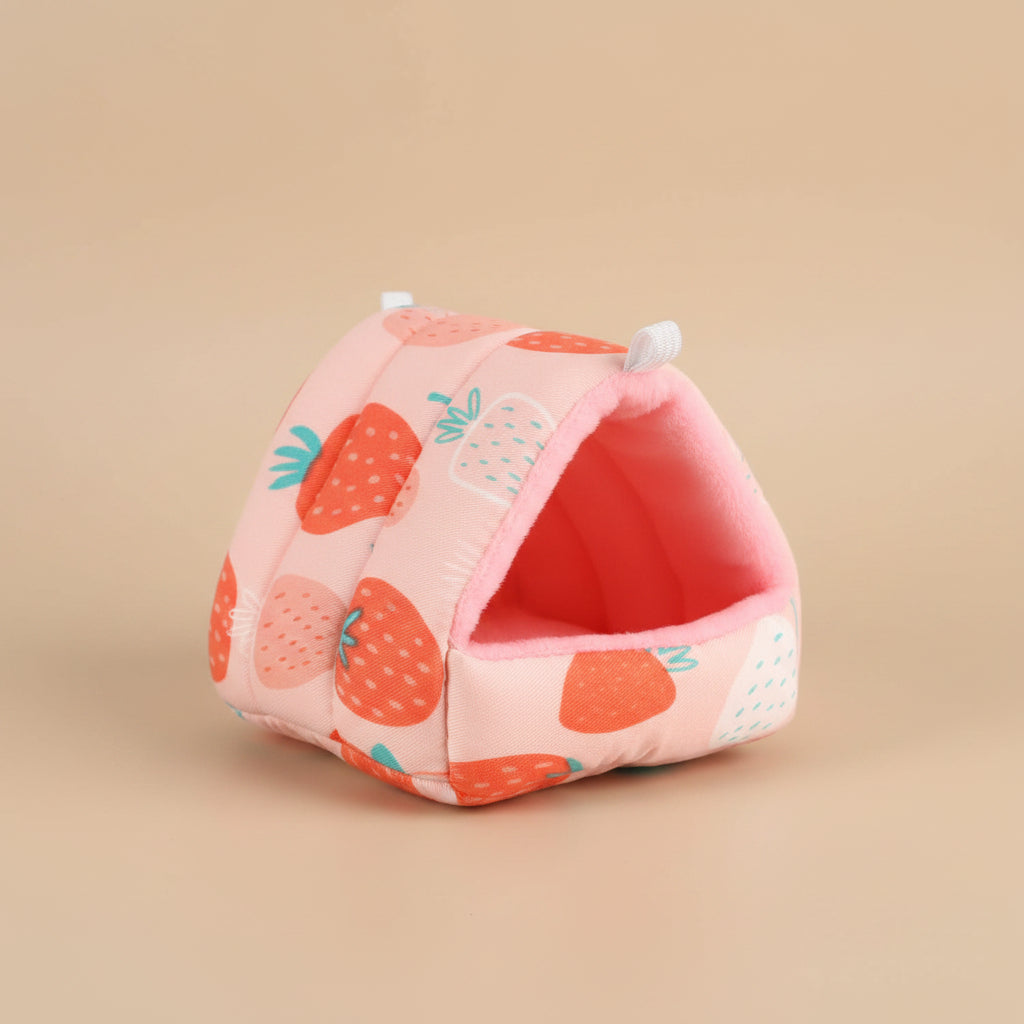 Pink small pet house bed with strawberry pattern on a beige background