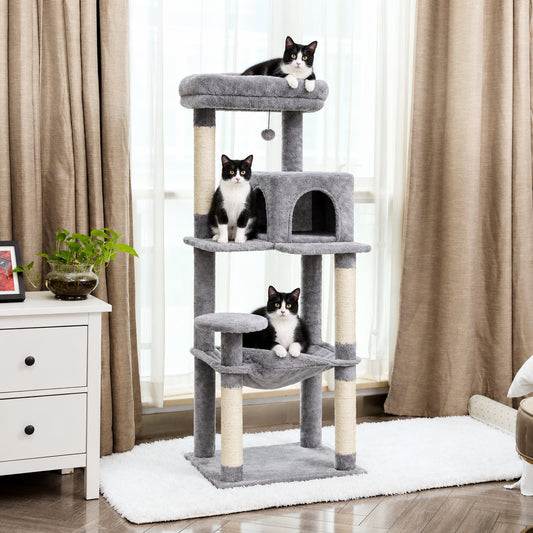 Cat tree with cats on multiple levels in a room with curtains and a plant.