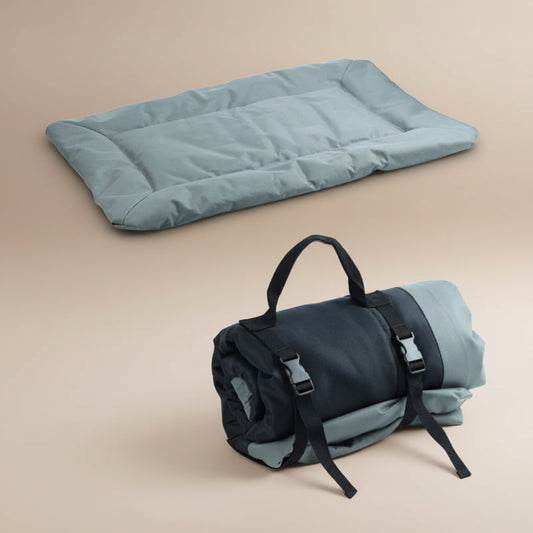 Gray/Green sleeping pad and rolled-up sleeping bag on a white background