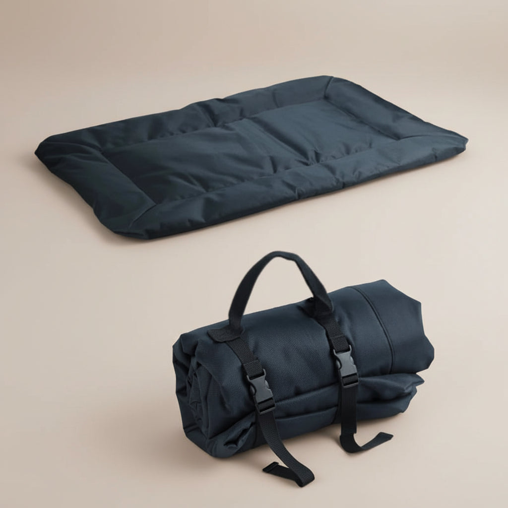 Black heated mat and rolled-up black bag on a beige background