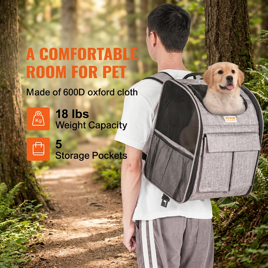 A gray and black pet carrier backpack worn on a person's back, with a golden retriever dog sitting in the top compartment.