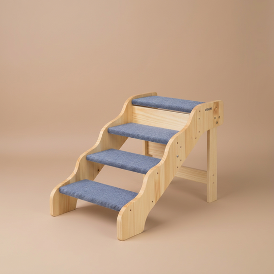 Dog using a set of wooden stairs with blue padding on a beige background