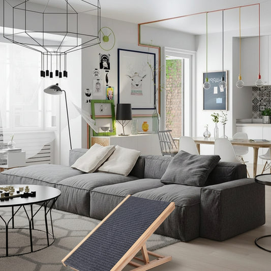 Small wooden ramp in a modern living room with gray sofa and decorative items.