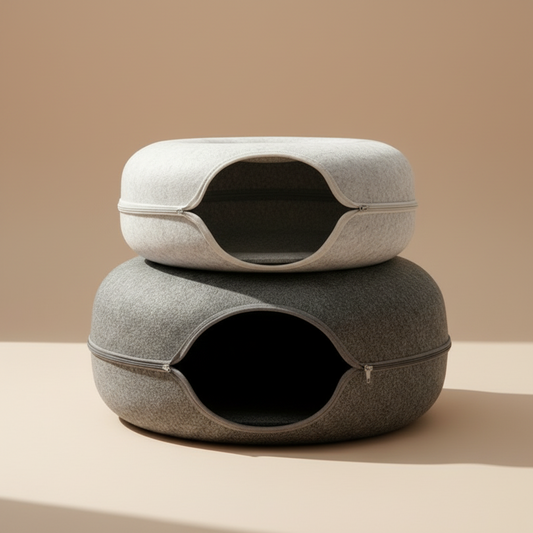 Two cats interacting with a modern pet tunnel bed in a cozy living room.