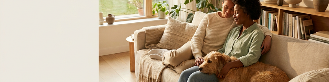 image of a couple relaxing on a sofa with their dog
