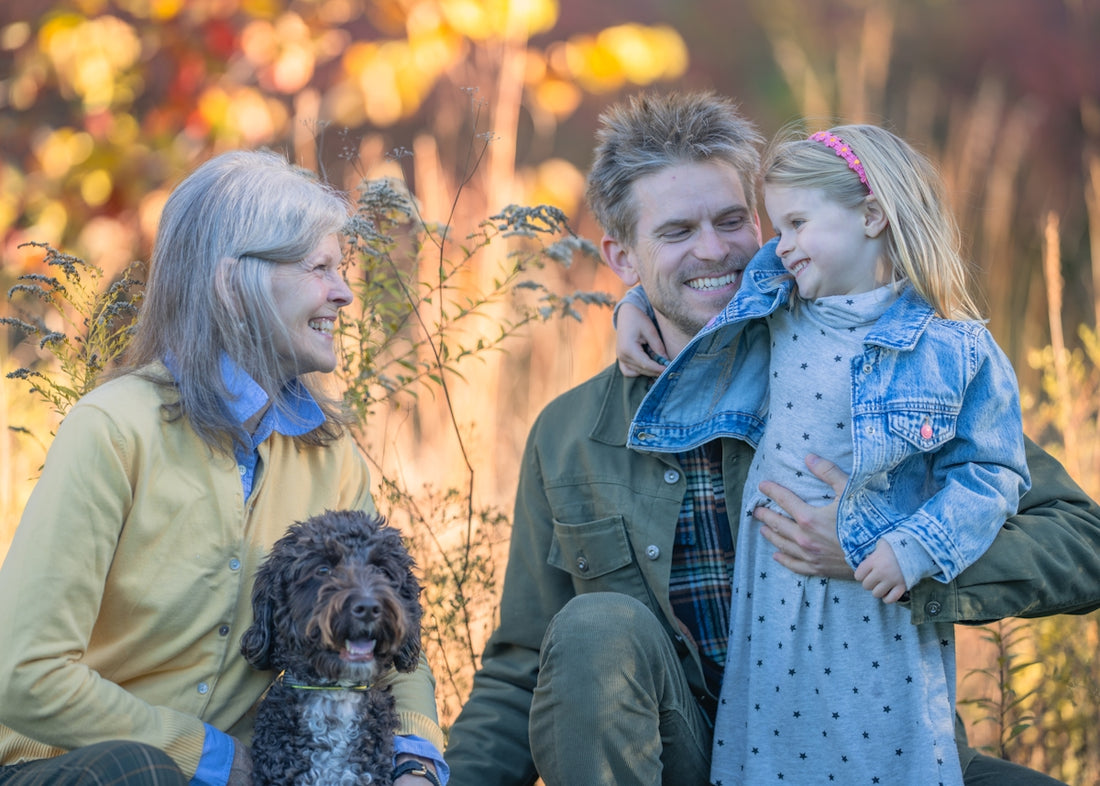 Family with dog in autumn foliage
