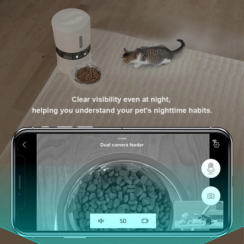 Cat near a dual camera feeder with smartphone displaying the feeder's interface.