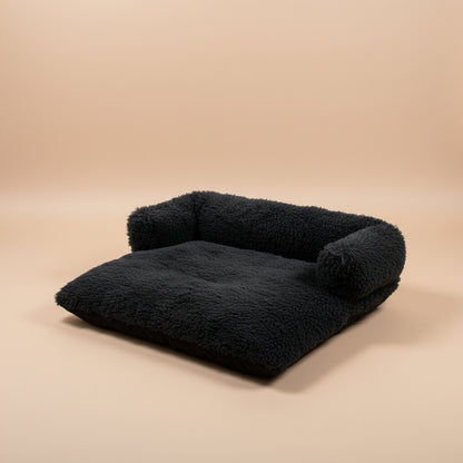 Dark gray fluffy blanket with brand name on a white background