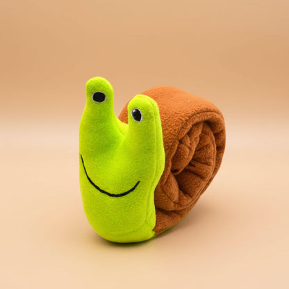 Toy snail with a green body and brown shell on a white background