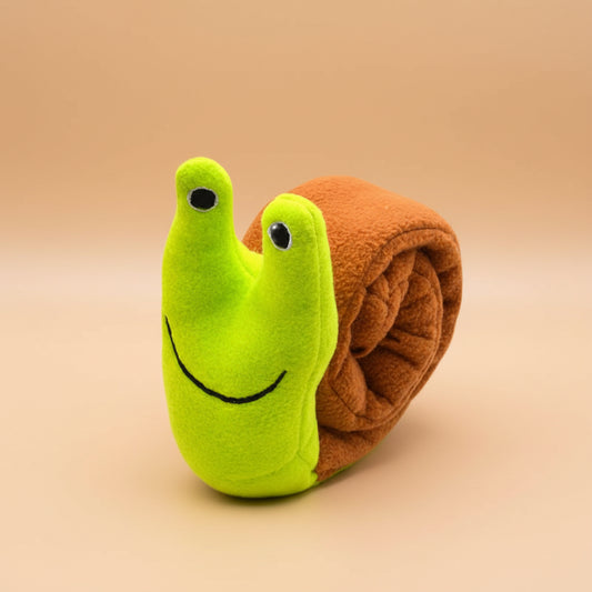 Toy snail with a green body and brown shell on a white background