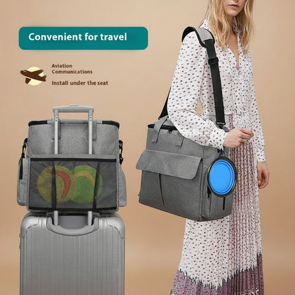 Woman holding a gray travel bag with aviation communication device, next to a suitcase.