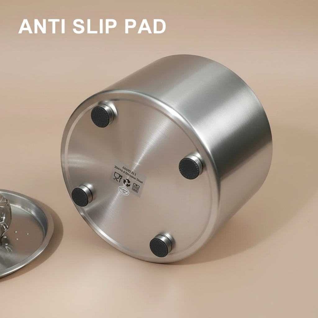 Bottom of Metallic cylindrical fountain displaying anti-slip pads on a beige surface