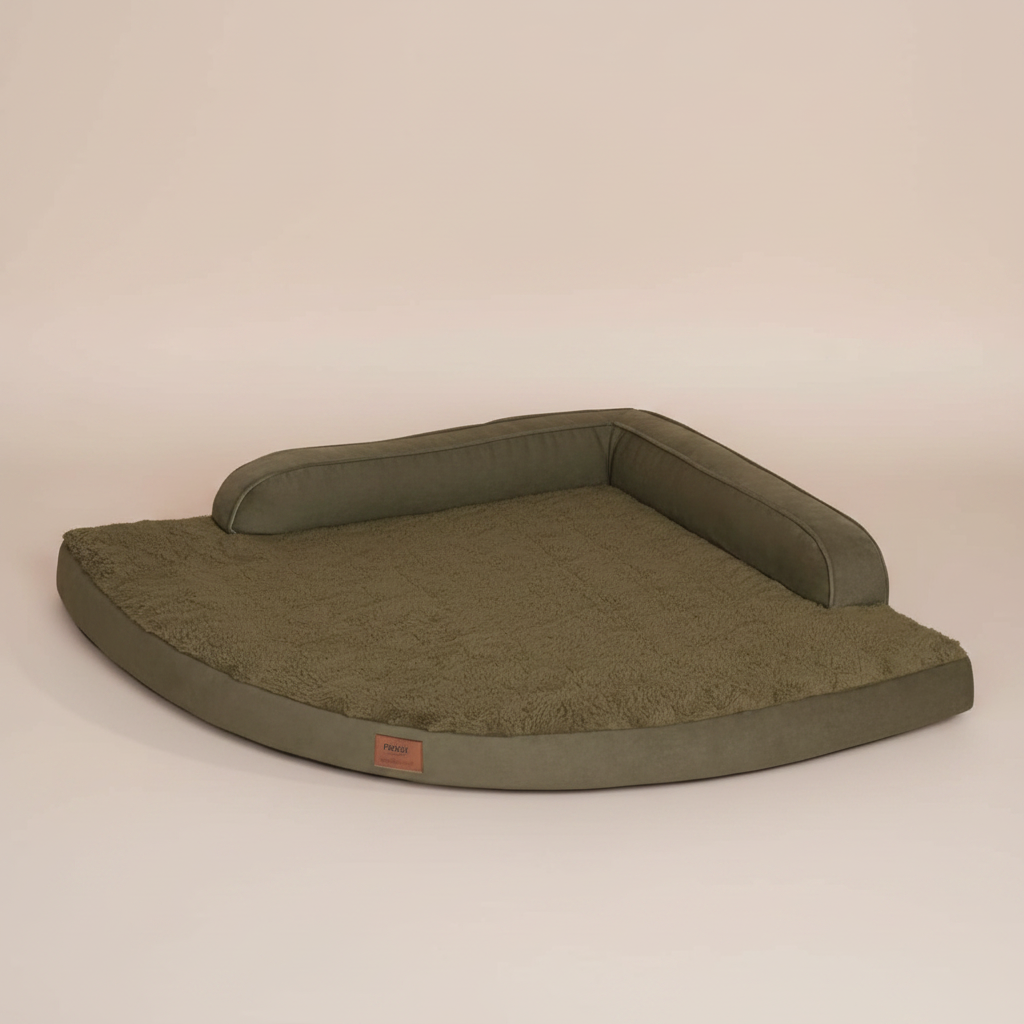 Image of a large green pet bed with a beige background.