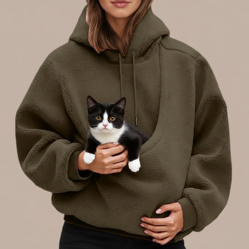 Person wearing a green hoodie with a cat  on a white background