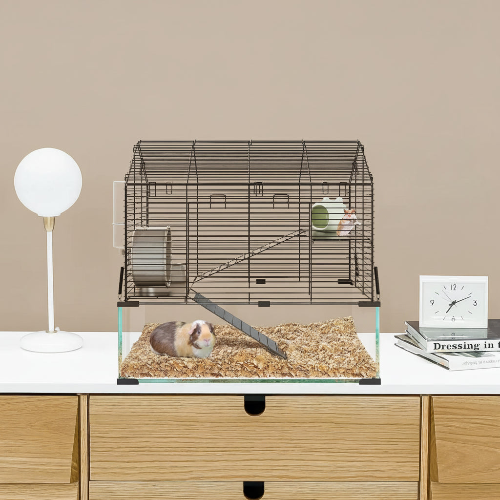 Small animal cage on a desk with a gray wall background
