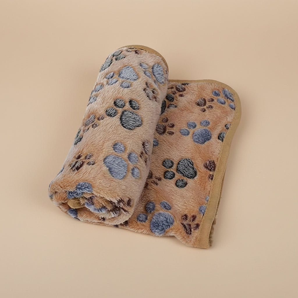 Folded blanket with paw print pattern on a brown background