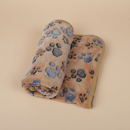 Folded blanket with paw print pattern on a brown background