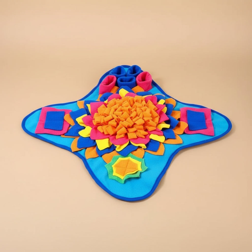 Colorful dog toy mat with a dog sitting next to it on a yellow surface.