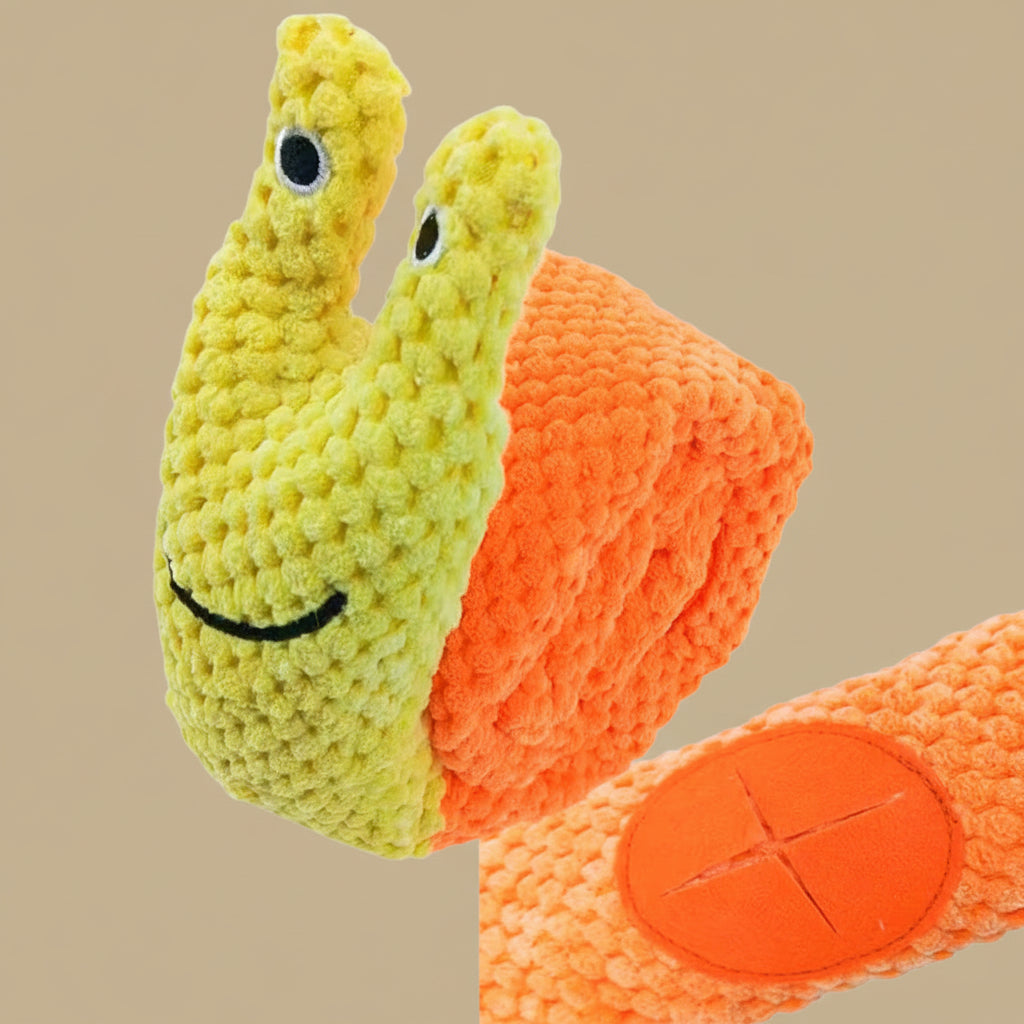 Plush snail toy with a smiling face on an orange shell against a white background