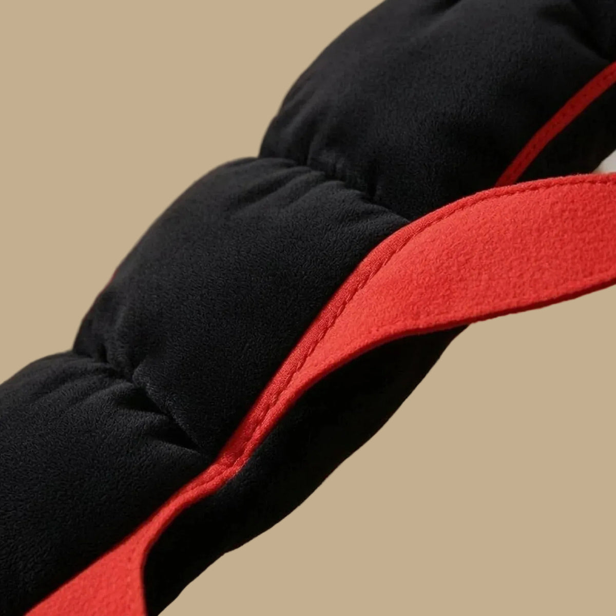 Close up of Black and red costume with a beige background