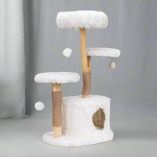 Cat tree with white cushioned platforms and wooden posts on a white background
