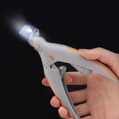 Hand holding a tool with a light on a black background