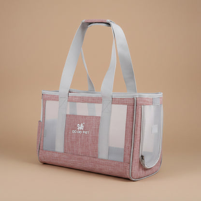 Pink pet carrier with mesh sides on a beige background