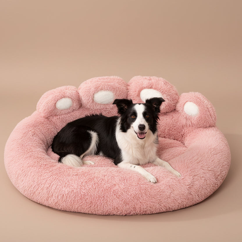 Dog lying on a pink paw-shaped pet bed against a beige background