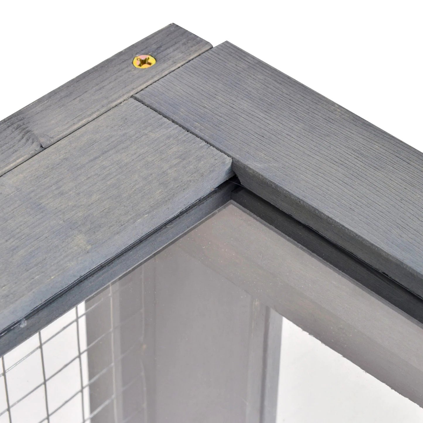 Close-up of a corner where two gray wooden planks meet with a small yellow screw.