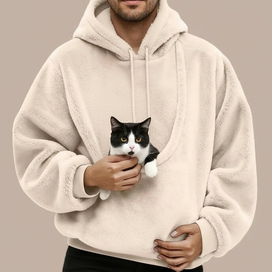 Person wearing a beige fleece hoodie with large pouch with a tuxedo cat inside.