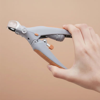 Hand holding a gray and orange tool against a light gray background