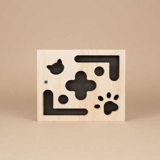 Wooden box cat toy with black scratching material inside and toys inside.
