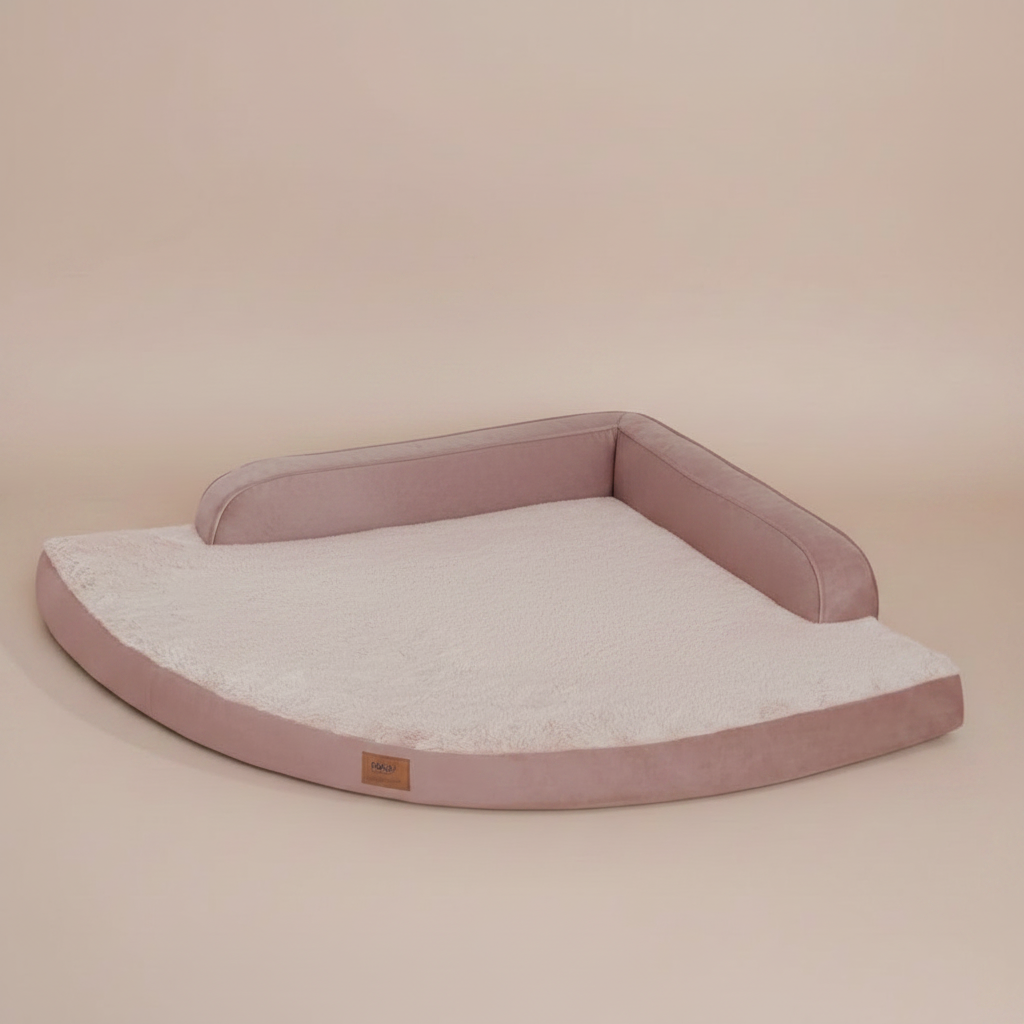 Image of a large, cushioned pet bed with a beige background.