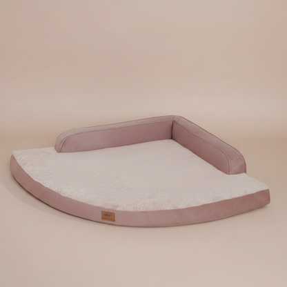 Image of a large, cushioned pet bed with a beige background.