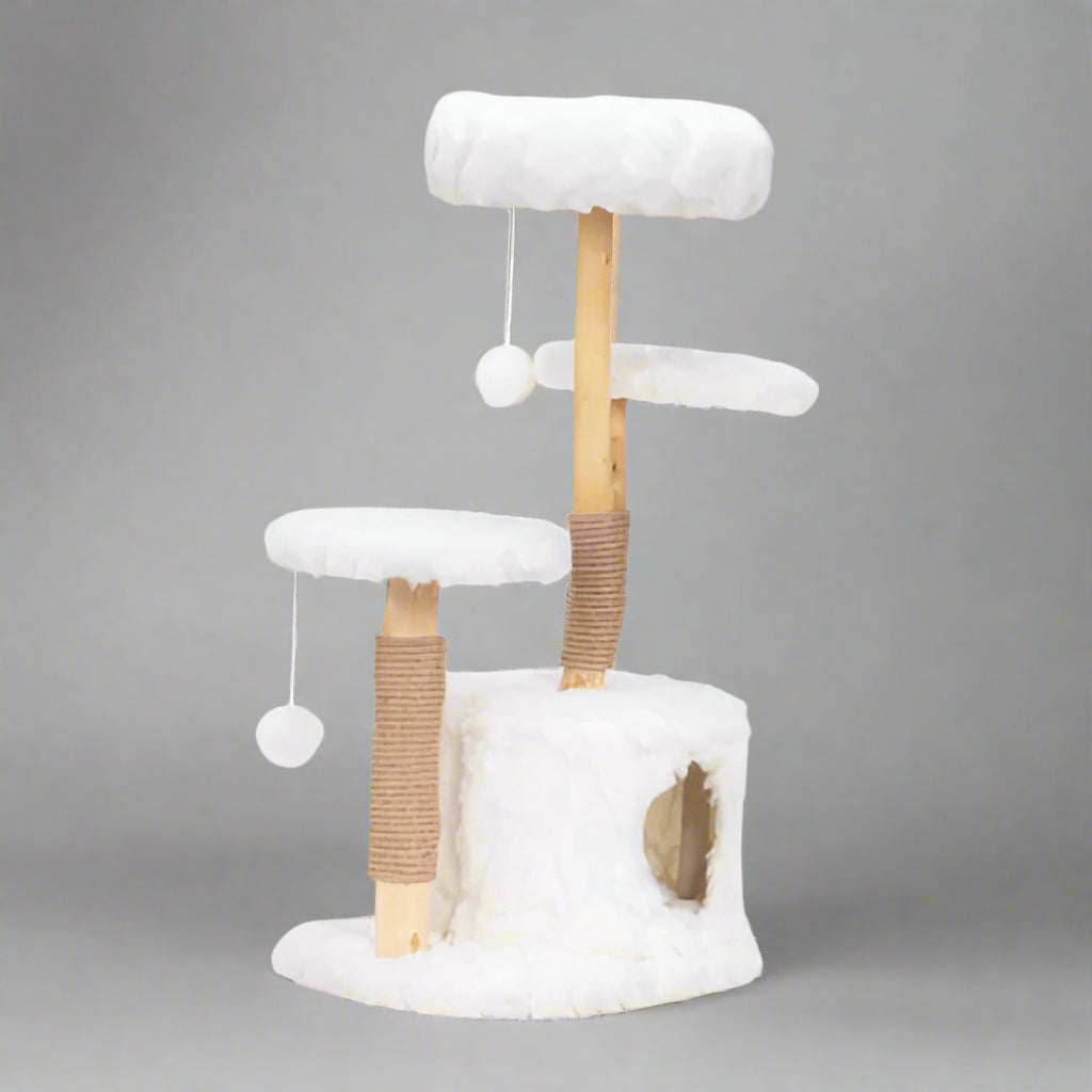 Cat tree with white cushioned platforms and wooden posts on a white background