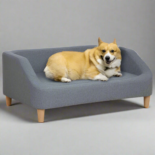 Dog lying on a gray pet bed with wooden legs against a white background