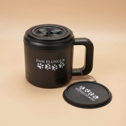 Black mug with 'Paw Plunger' branding on a beige background
