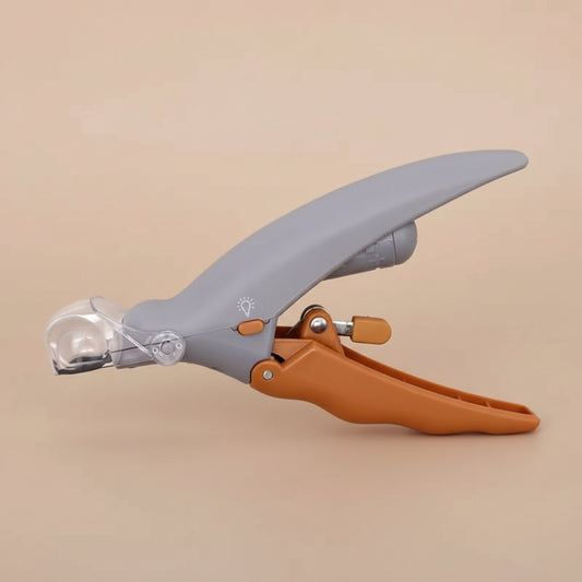 Pet nail trimmer with gray blade and brown handle on a beige background