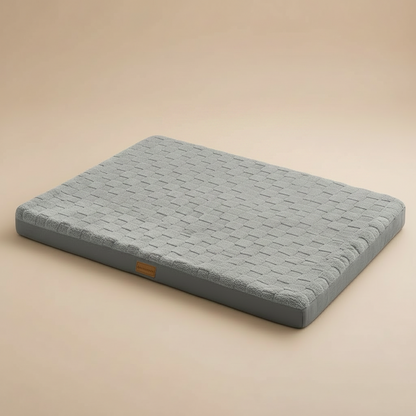 Gray orthopedic pet bed on a beige background.