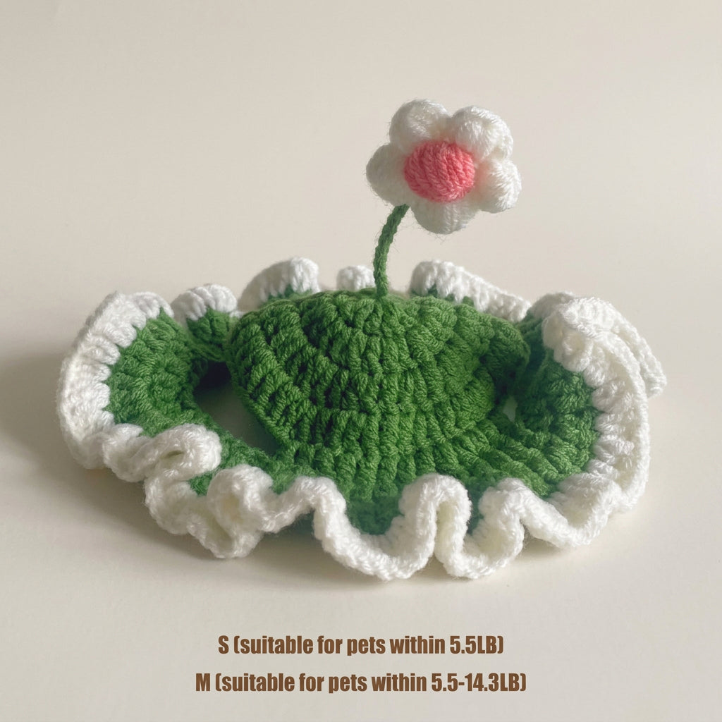 Knitted green heart with white border and pink flower on a beige background