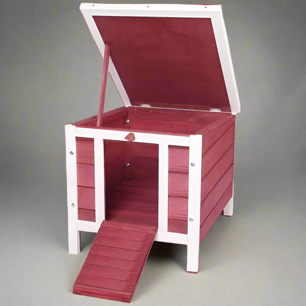 Red wooden pet house with a white frame on a white background