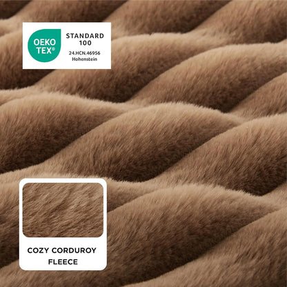 Close-up of brown cozy corduroy fleece fabric with OEKO-TEX Standard 100 label.