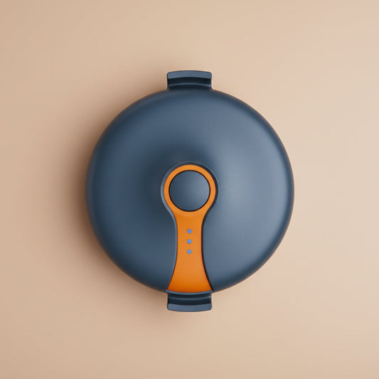 Small Round blue gps pet tracker with an orange section on a beige background