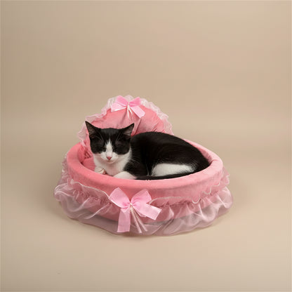 Pink pet bed with ruffles and bows on a beige background.
