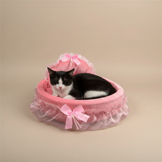 Pink pet bed with ruffles and bows on a beige background.