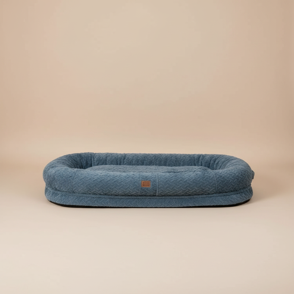large blue pet bed with a beige studio background.