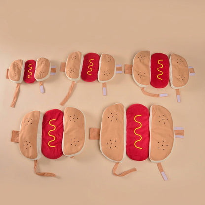 Hot dog-shaped costumes in different sizes, displayed on a beige background
