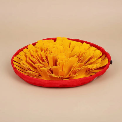 Red pet bed with yellow crinkled fabric on a white background