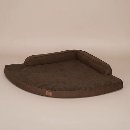 Image of a brown pet bed with a beige background.